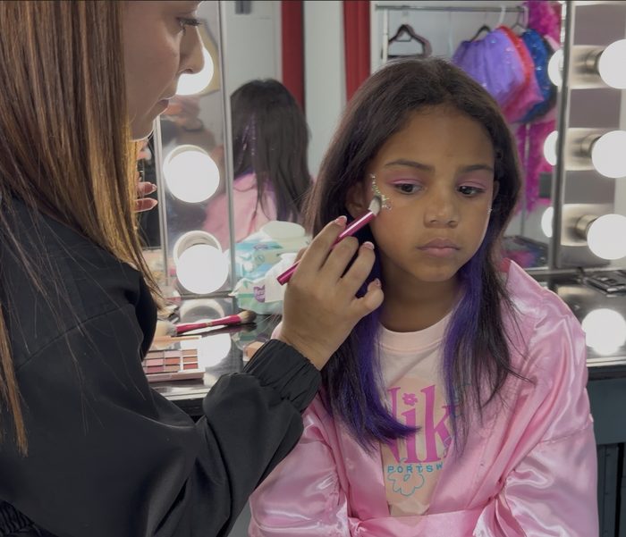 Girl with finished pink eyeshadow and glitter makeup look